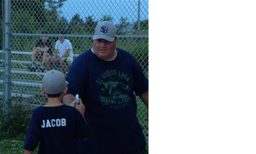 President/ Coach handing trophies to team